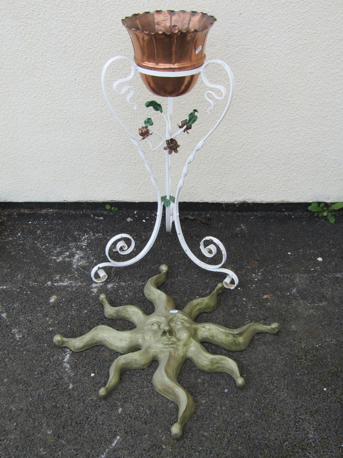 A small copper jardiniere with crimped rim set in a painted ironwork stand with scrolled supports