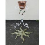 A small copper jardiniere with crimped rim set in a painted ironwork stand with scrolled supports