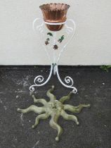 A small copper jardiniere with crimped rim set in a painted ironwork stand with scrolled supports