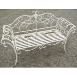 A contemporary weathered cream painted two seat garden bench loosely in the Regency style with swept