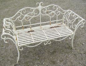 A contemporary weathered cream painted two seat garden bench loosely in the Regency style with swept