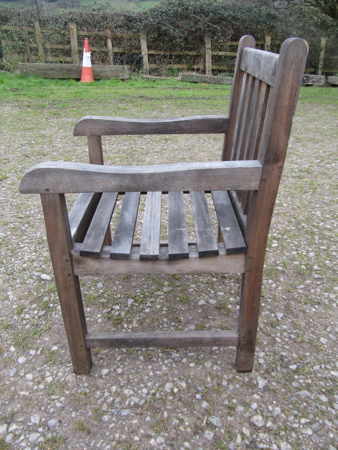 A weathered circular teak table and four associated armchairs (5) - Image 4 of 8