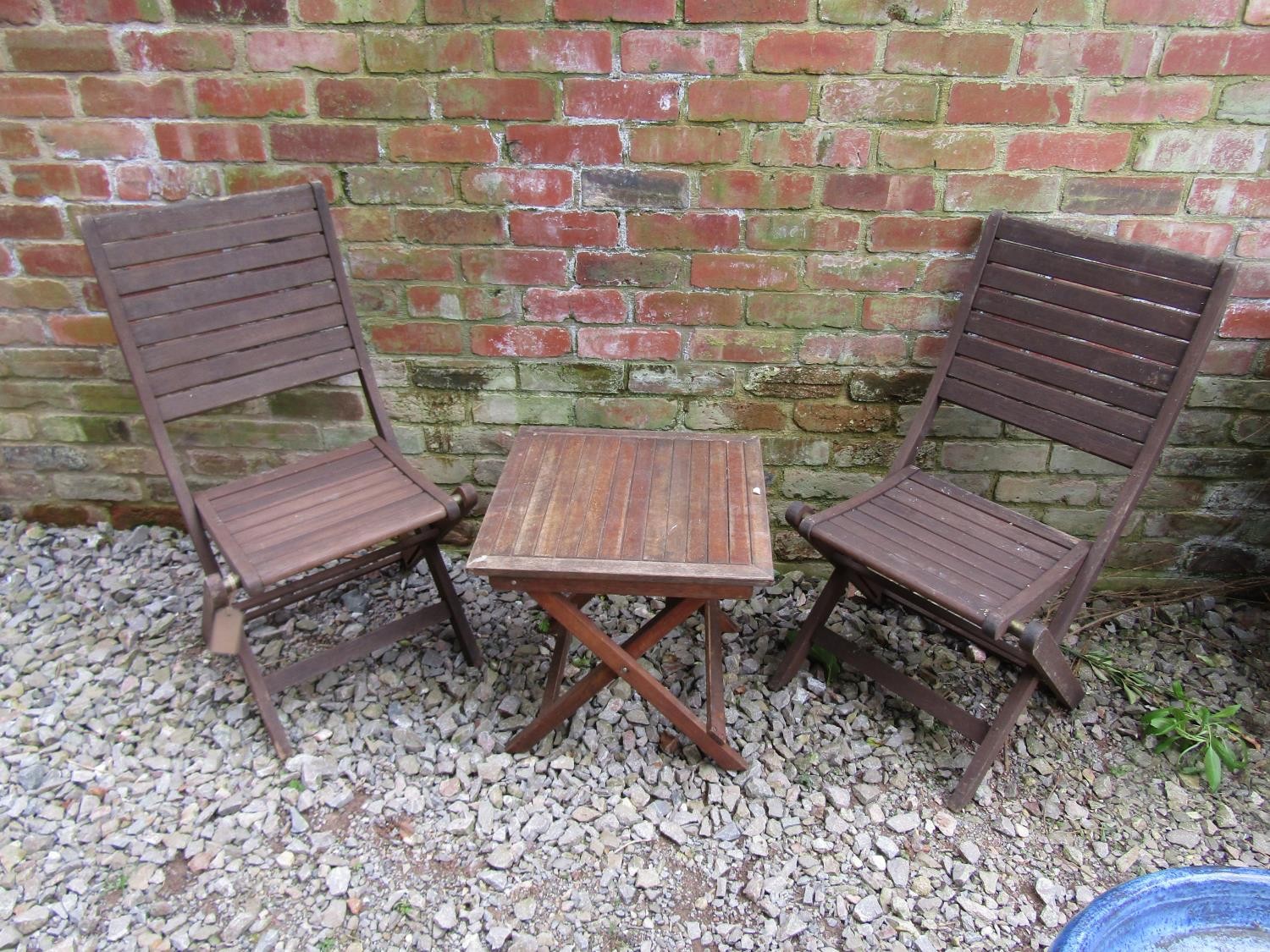 A weathered stained hardwood three piece folding terrace set with slatted detail, the table 50 cm - Image 3 of 3