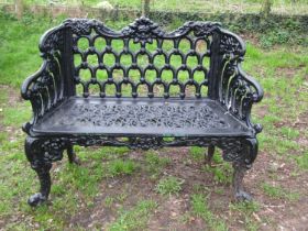 A good quality heavy gauge cast iron two seat garden bench with shaped outline and decorative