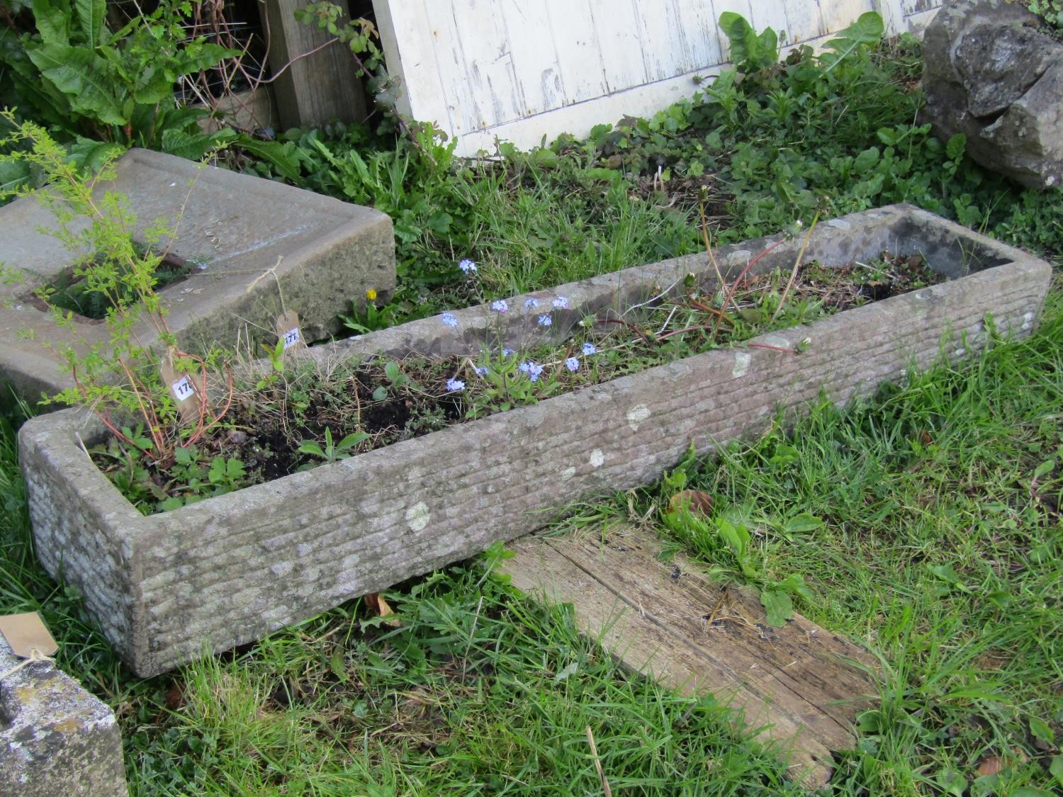 A good weathered narrow rectangular carved stone trough, 18 cm high x 152 cm long x 30 cm wide