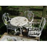 A small weathered cast iron terrace table with decorative pierced circular top raised on scrolled