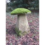 A limestone staddle stone and cap, moss encrusted, 70 cm in height