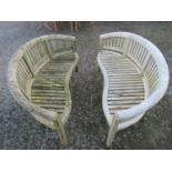 A pair of weathered teak banana shaped garden benches 160 cm wide