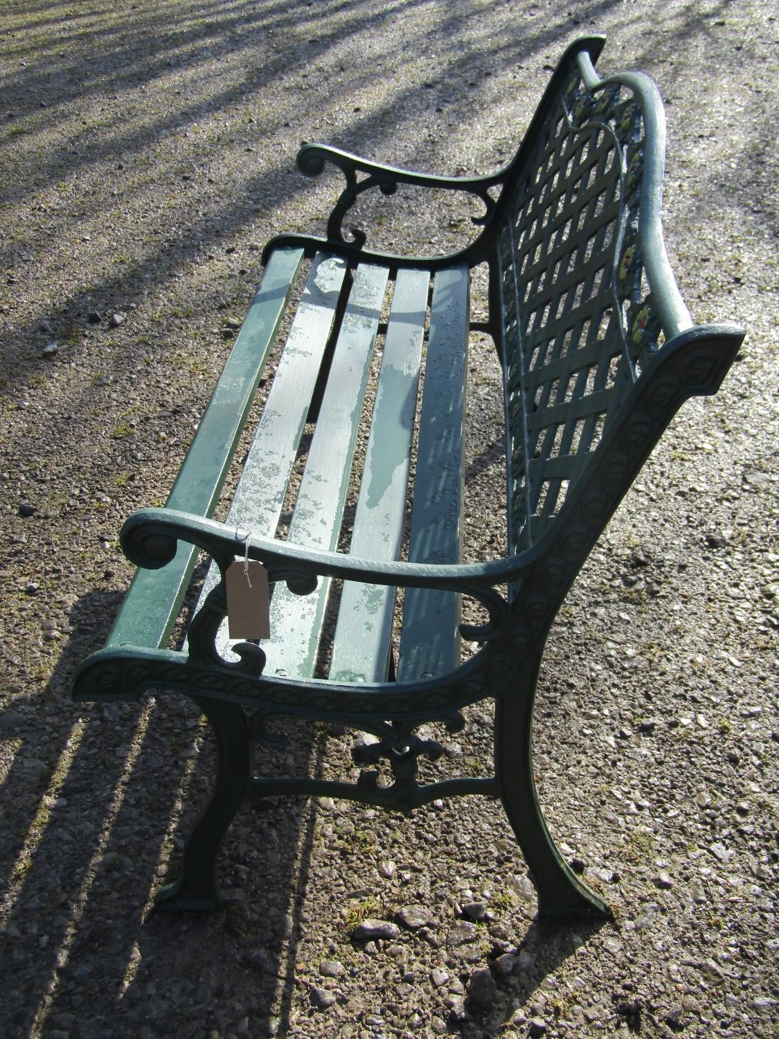 A green painted garden bench with wooden slatted seat beneath a cast iron pierced lattice panelled - Image 3 of 6