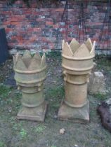 Two similar weathered Victorian crown top chimney pots, the larger being 90cm high
