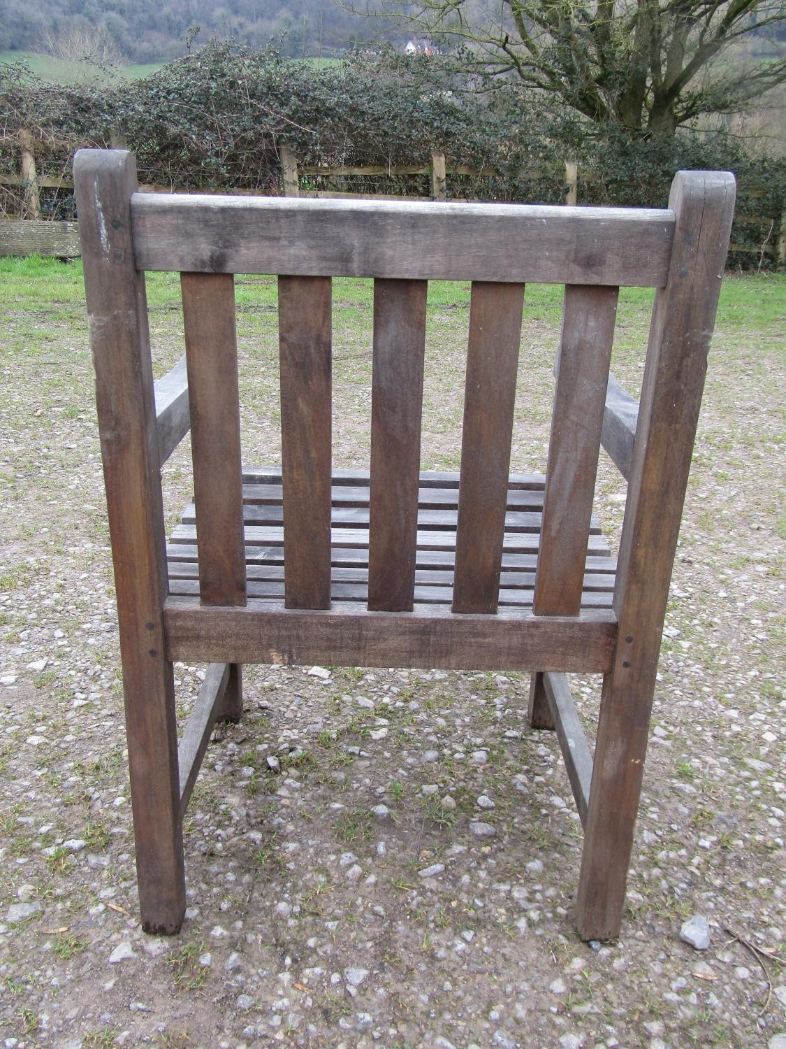 A weathered circular teak table and four associated armchairs (5) - Image 5 of 8