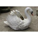 A heavy antique cast iron planter in the form of a swan with painted finish, 38cm high, 45cm wide