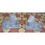 A pair of cast composition stone recumbent lions 33 cm high x 40 cm long x 20 cm wide