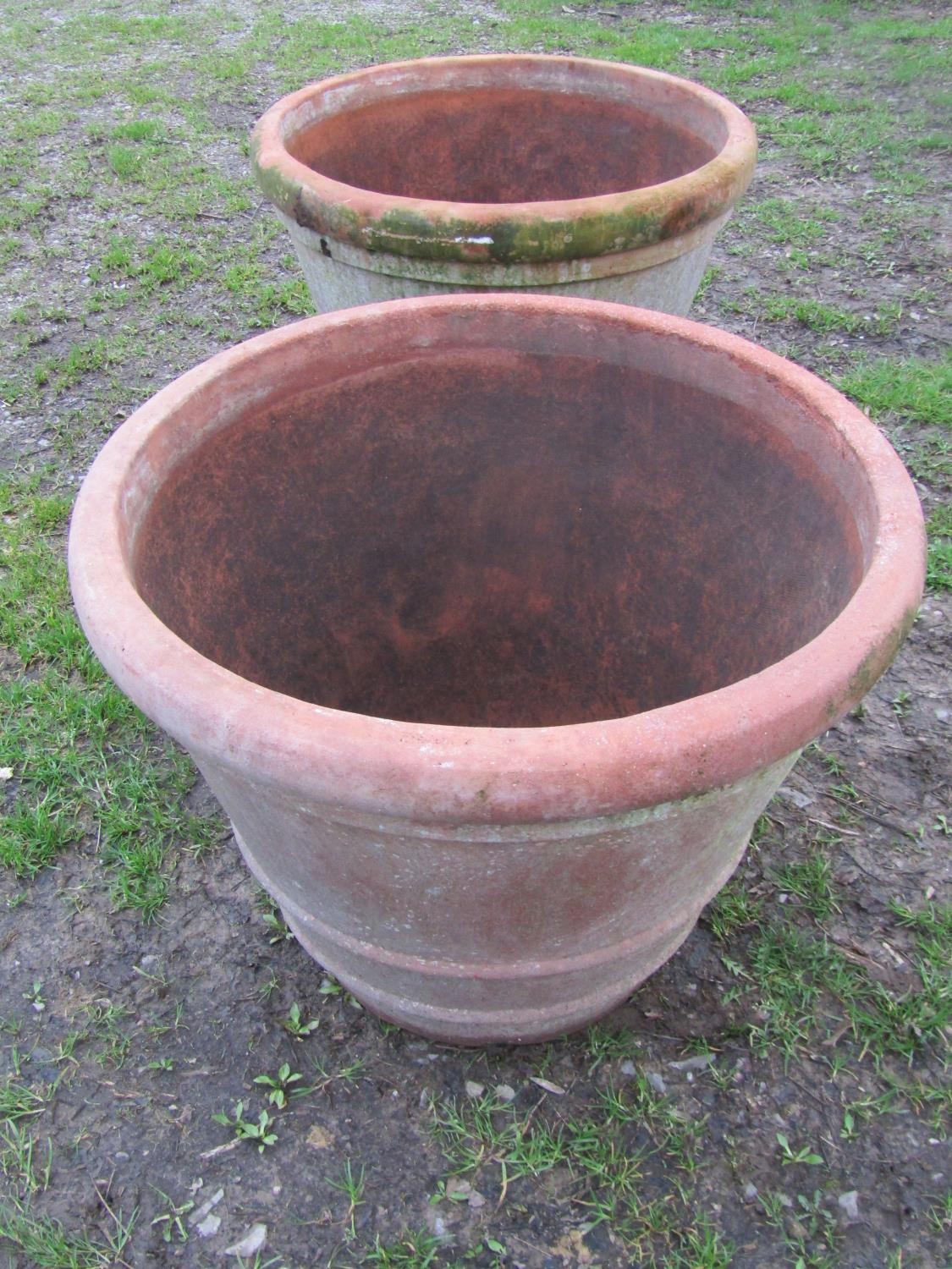 A pair of large weathered terracotta planters of circular tapered and simple ribbed form, 56 cm high - Image 3 of 6