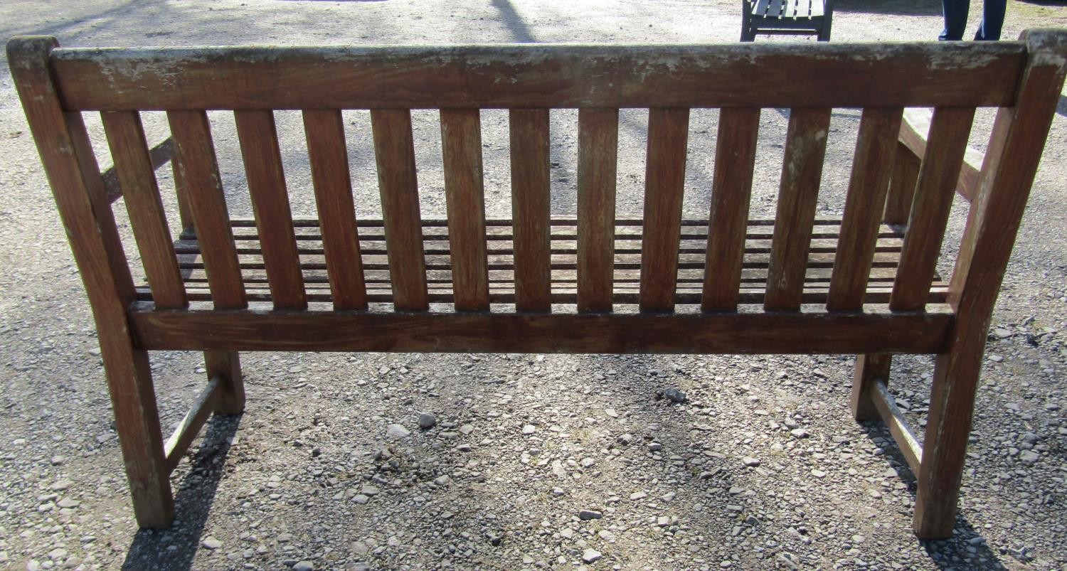 A pair of good quality heavy gauge weathered teak three seat garden benches with slatted seats and - Image 5 of 7