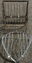 Two vintage iron wall mounted stable mangers of varying size, the largest 61 cm high x 92 cm wide