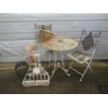 A heavy gauge weathered cream painted metal three piece garden terrace set with lattice detail,