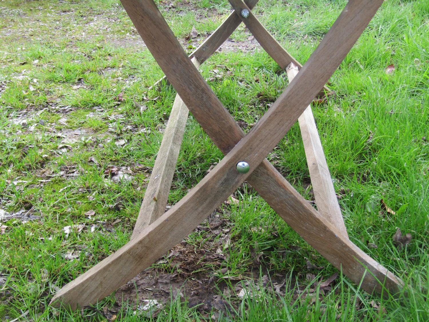 A Bramblecrest weathered teak folding garden table with rectangular slatted panelled top raised on x - Image 7 of 8