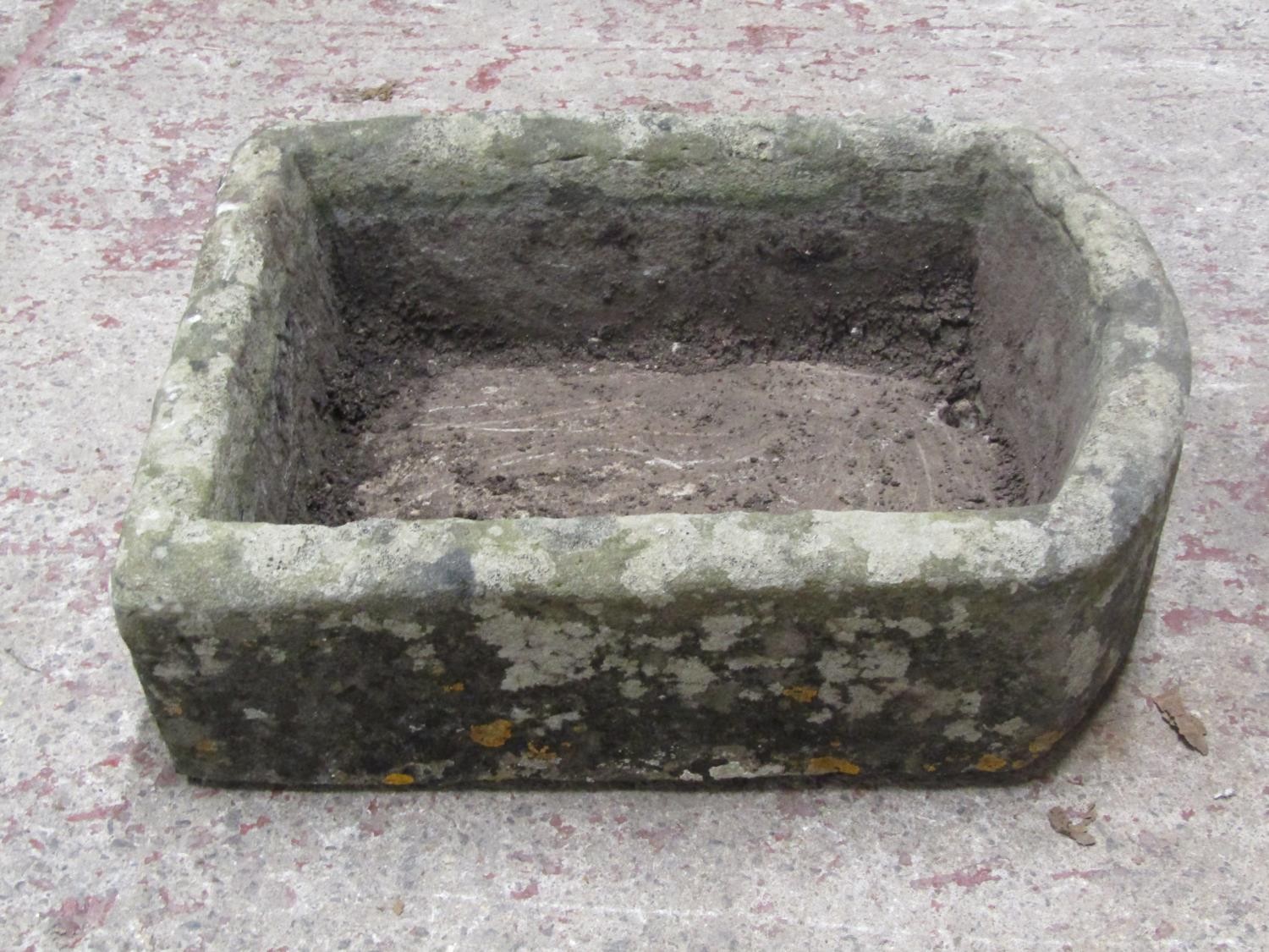 A weathered rectangular natural stone trough with D shaped end, 18cm high x 62cm x 47cm