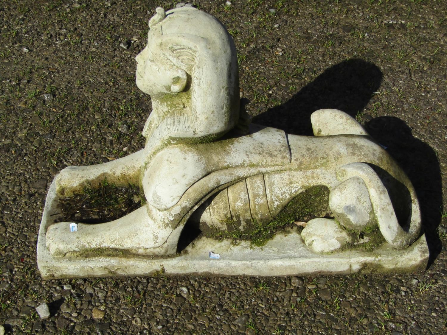 A weathered cast composition Sphinx terrace/pier ornament 50 cm high x 74 cm long x 29 cm wide