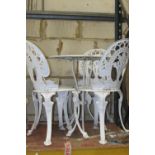 A painted cast alloy terrace table with decorative circular pierced top together with a set of 4