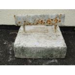 A simple iron boot scraper set in a painted composite stone block, the block 30 cm square