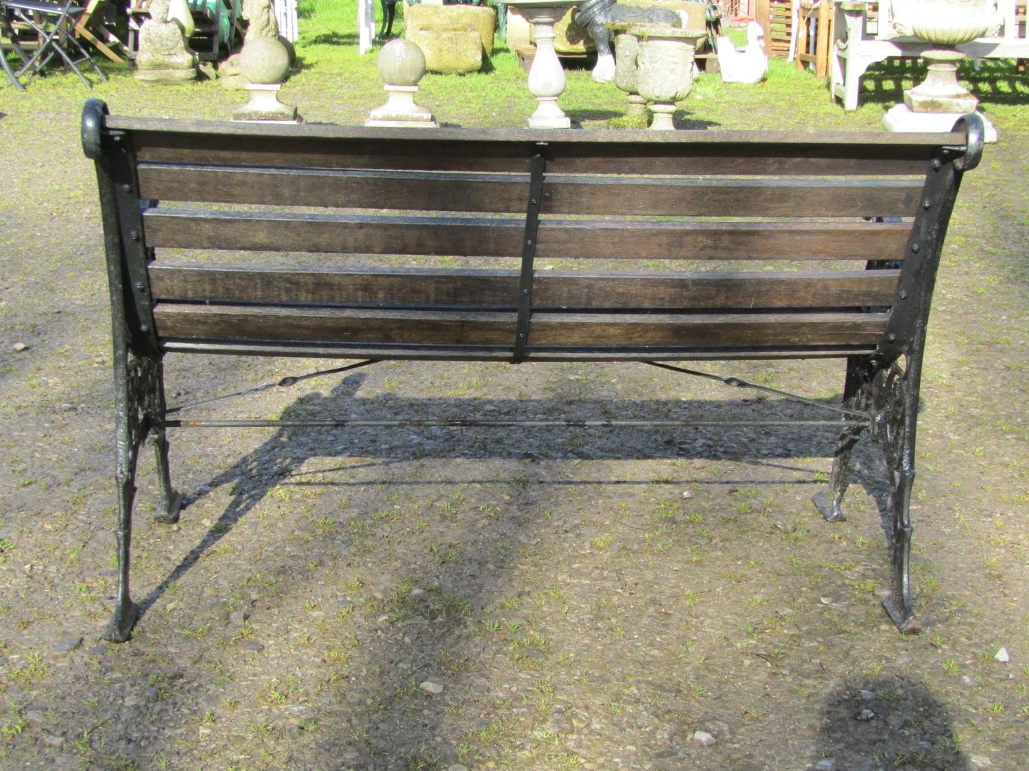 A two seat garden bench with stained wooden slatted seat raised on decorative pierced and scrolled - Image 4 of 4