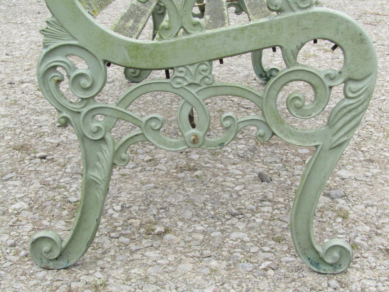 A light green painted garden bench with wooden slatted seat raised on decorative pierced and - Image 5 of 5