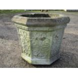 A weathered cast composition stone octagonal gothic style planter with repeating panels, 41 cm