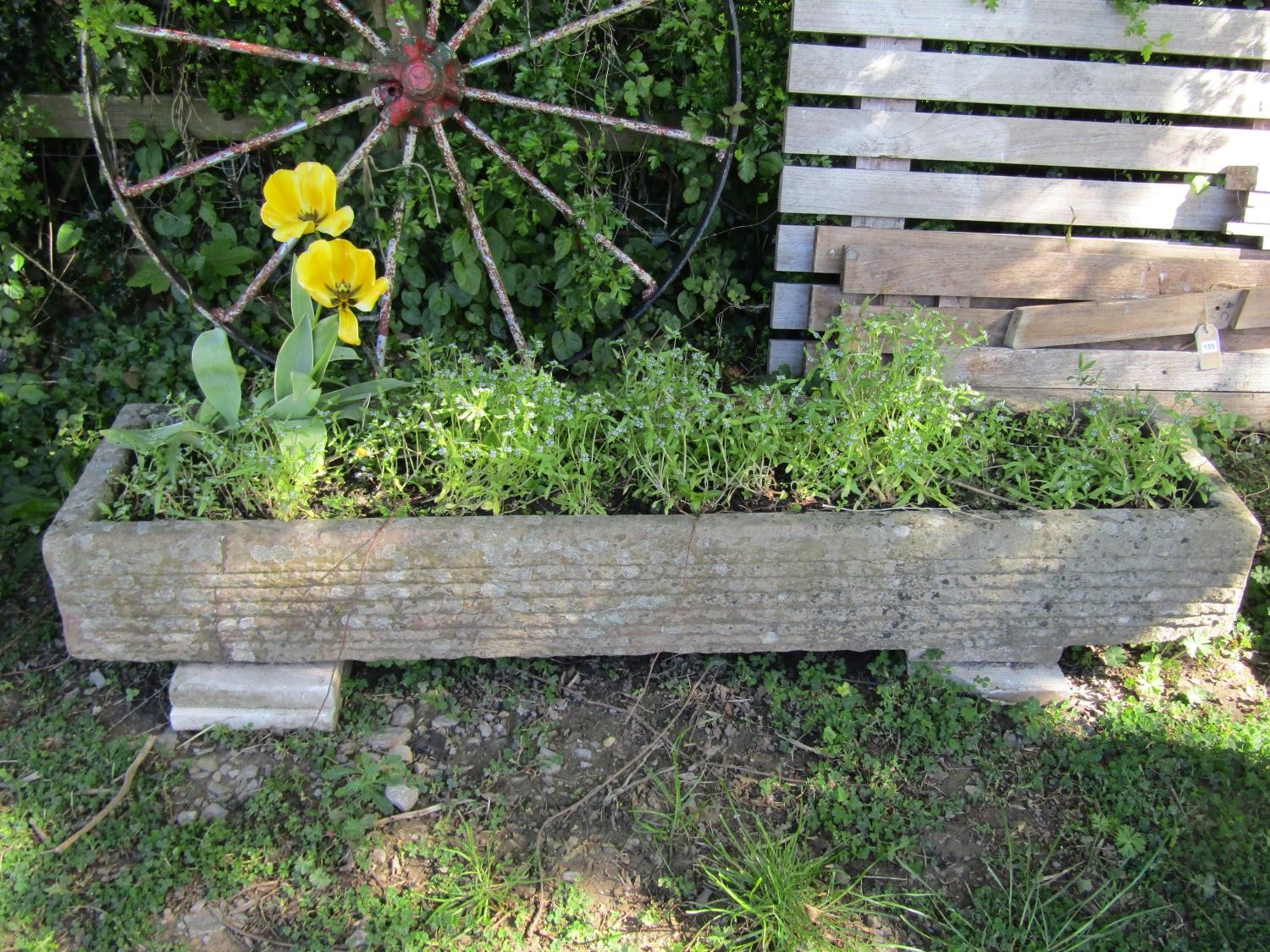 A long weathered carved natural stone trough of rectangular form, 20cm high, 162cm x 38cm