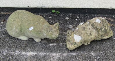 Two small weathered cast composition stone garden ornaments in the form of recumbent pensive cats