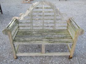 A weathered teak Lutyens style two seat garden bench, 136 cm wide