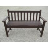 A Wrinch vintage stained teakwood two seat garden bench with slatted seat and back, 127 cm wide