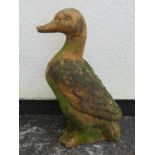 A weathered terracotta garden ornament in the form of a duck 55 cm high