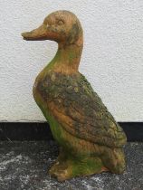 A weathered terracotta garden ornament in the form of a duck 55 cm high