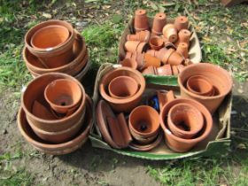 A large quantity of terracotta flower pots and planters of varying size and design to include glazed