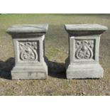 A pair of cast composition stone square cut and stepped pedestals, with repeating foliate panels,