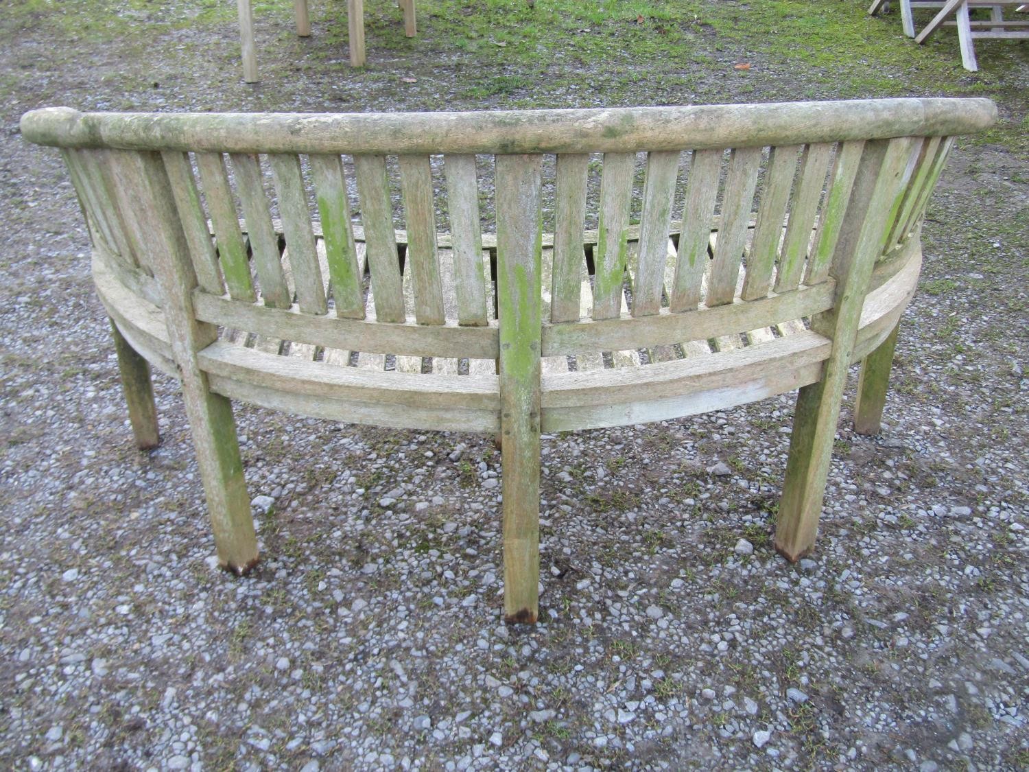 A pair of weathered teak banana shaped garden benches 160 cm wide - Image 4 of 7