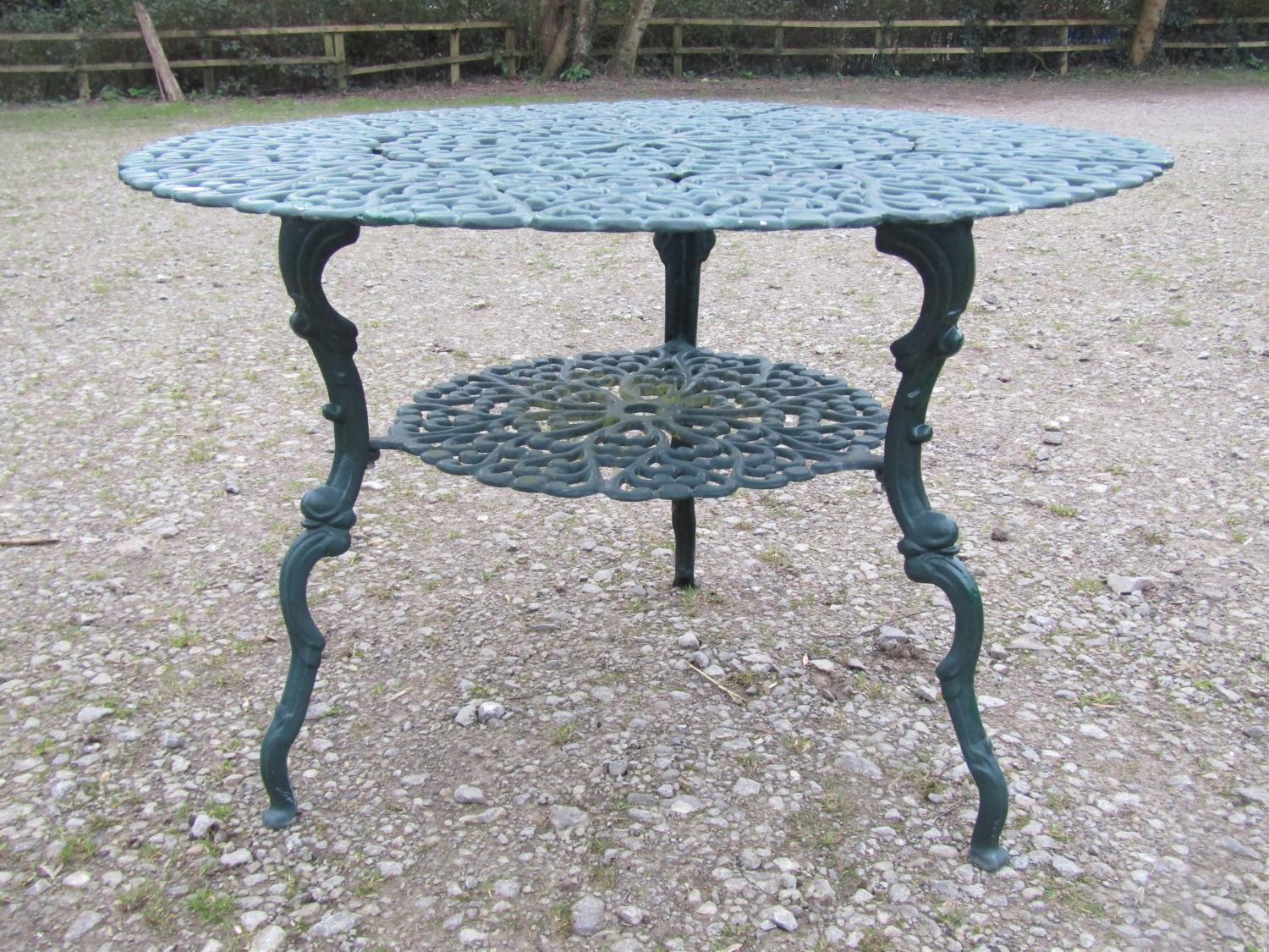 A green painted cast alloy circular two tier garden terrace table, with decorative repeating 'c' - Image 6 of 7