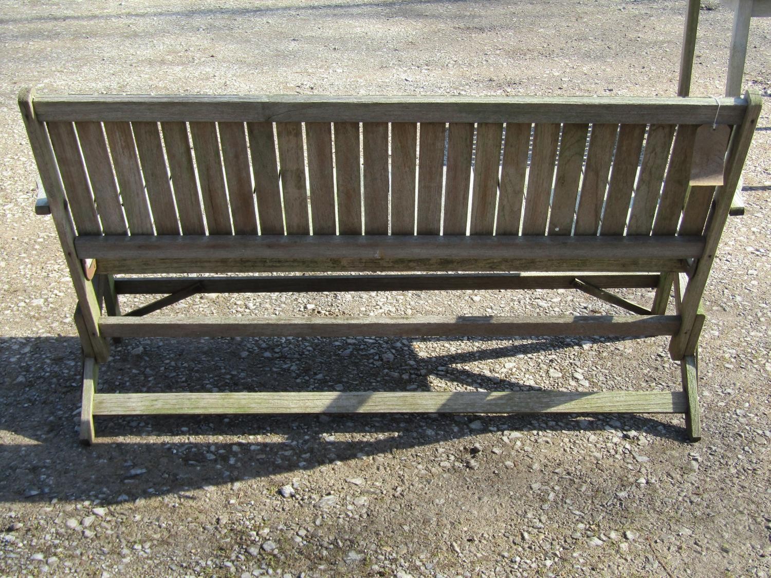 A weathered (silvered) teak garden suite comprising a folding bench with slatted seat and back 141 - Image 6 of 6