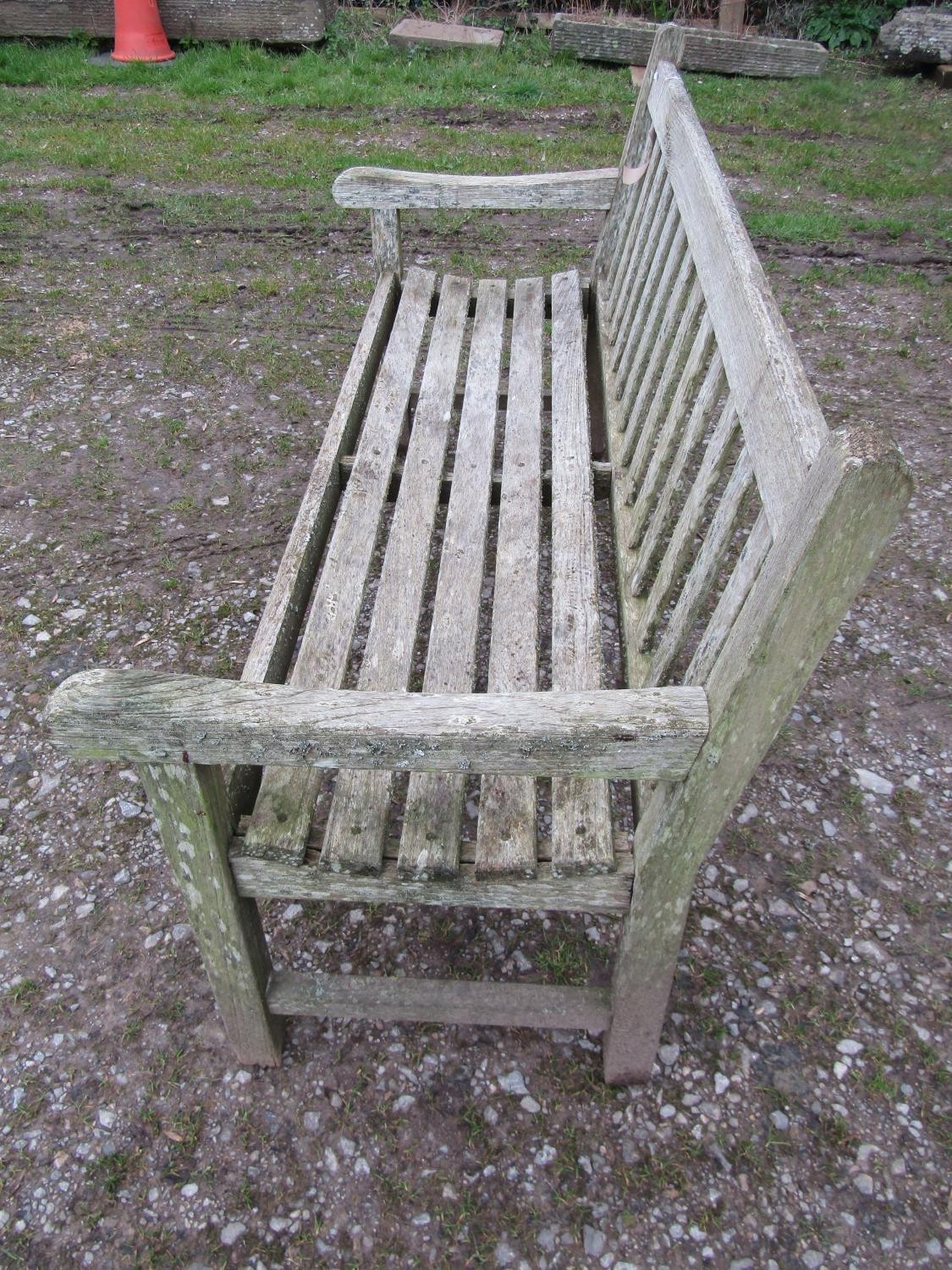 A weathered teak Tiger Trading three seat traditional garden bench with slatted seat and back, 153cm - Image 2 of 5