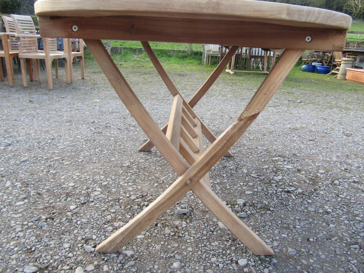 A contemporary weathered Cotswold collection garden table with oval slatted top raised on x framed - Image 7 of 9