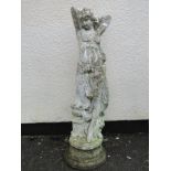 A painted and weathered cast composition stone garden statue in the form of a maiden with long