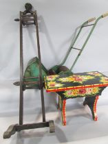 A child's lawn mower, a 19th century wooden wool winder, a brightly painted barge style stool