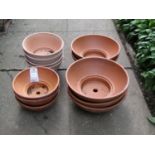Twelve shallow squat circular terracotta planters (varying size), the larger examples 14 cm x 36