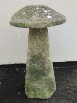 A weathered natural limestone straddle stone and cap, 95cm high, 58cm diameter apprrox