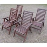 A set of four stained and weathered contemporary folding hardwood garden armchairs with slatted