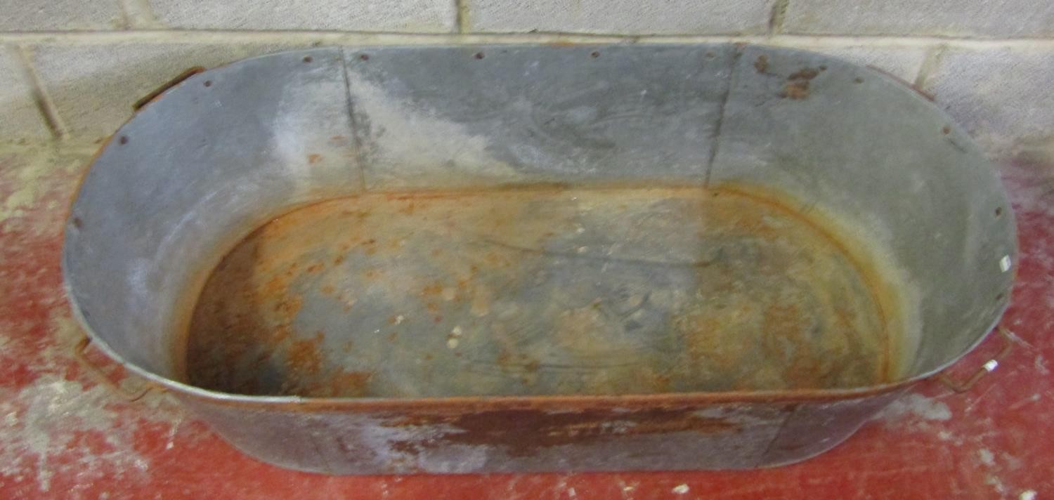 A vintage oval galvanised tin bath with iron fittings, 30 cm high x 119 cm x 55 cm - Image 2 of 3