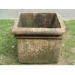A weathered square tapered terracotta planter with moulded rim (af), 41 cm high x 52 cm square