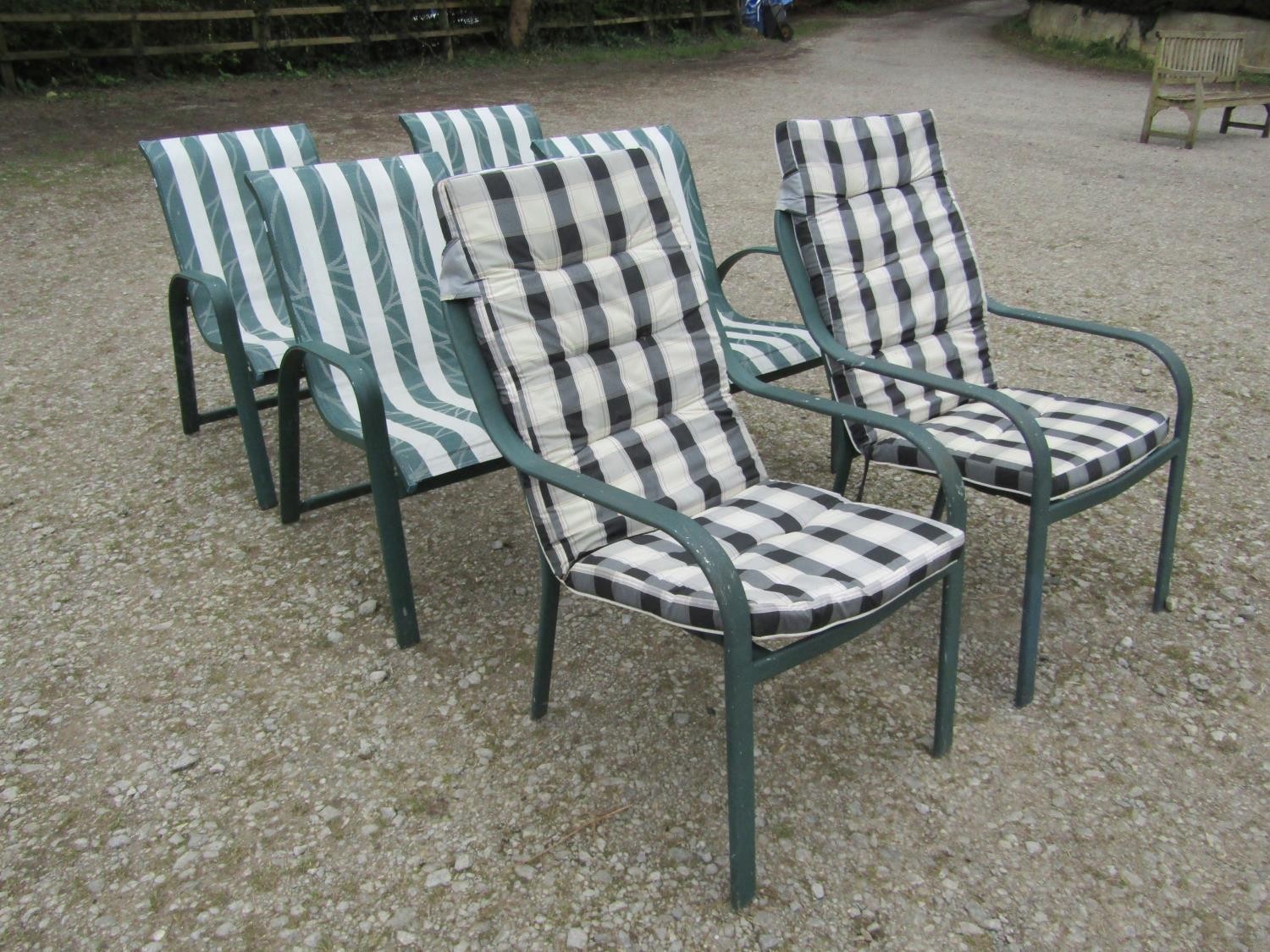 A set of four green painted aluminium stacking garden chairs together with a further similar pair